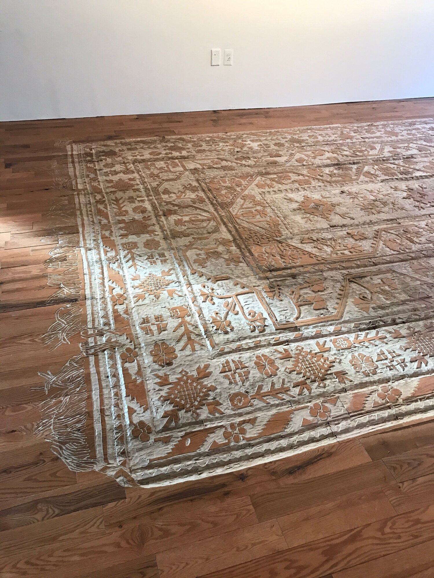 Spanish artist carves a rug into wooden floors